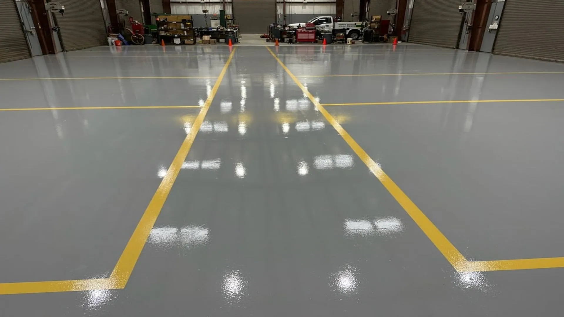 Industrial epoxy flooring with yellow safety lines in a clean warehouse in Idaho