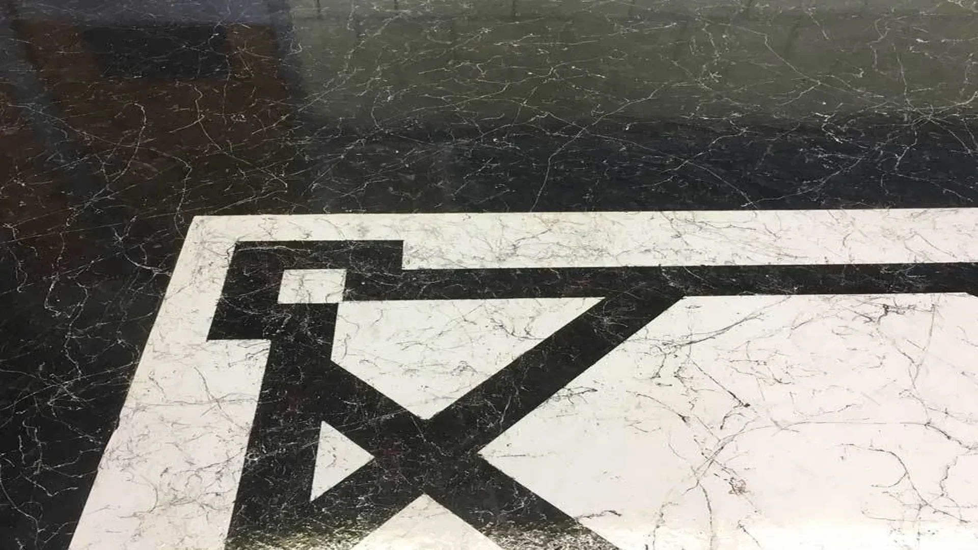 Close-up of epoxy flooring with Italian marble pattern and black border detail in Idaho.