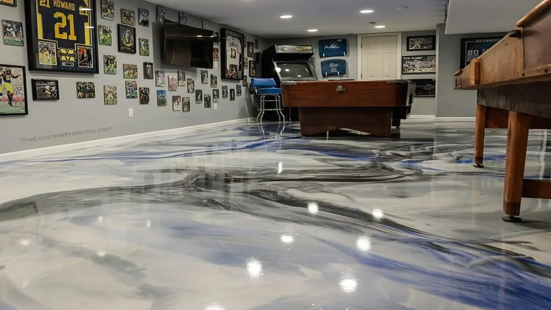 Metallic Marble epoxy flooring in an Idaho basement game room by TVS Coatings with black, white, and blue swirls