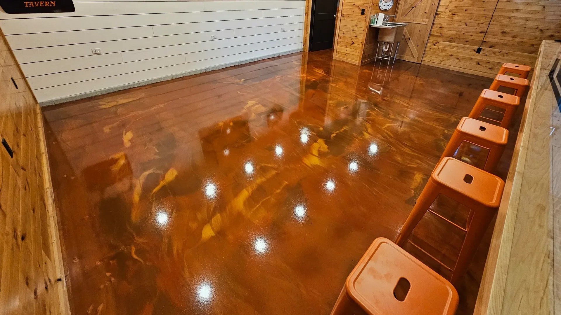Metallic Marble epoxy flooring system installed in a commercial bar-style space by TVS Coatings in Idaho with a high-gloss finish