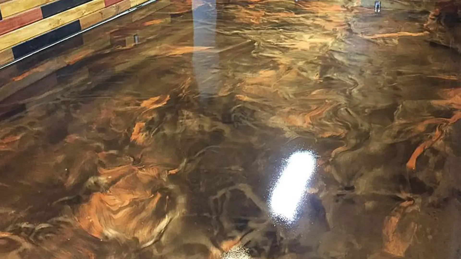 Interior Metallic Marble epoxy flooring installed by TVS Coatings in Idaho with deep bronze and copper color blends