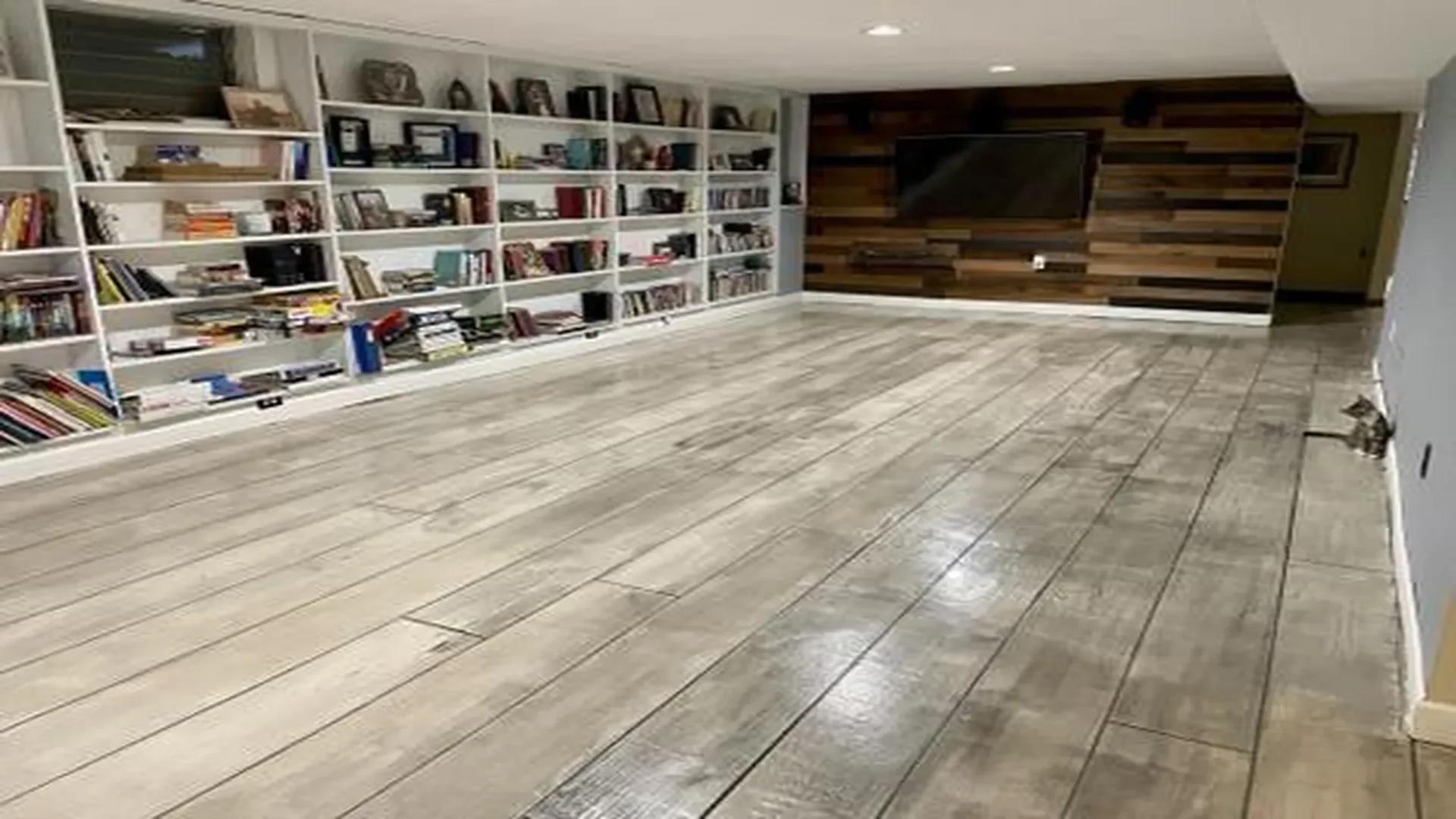 Rustic Concrete Wood epoxy flooring system in a finished basement installed by TVS Coatings in Idaho