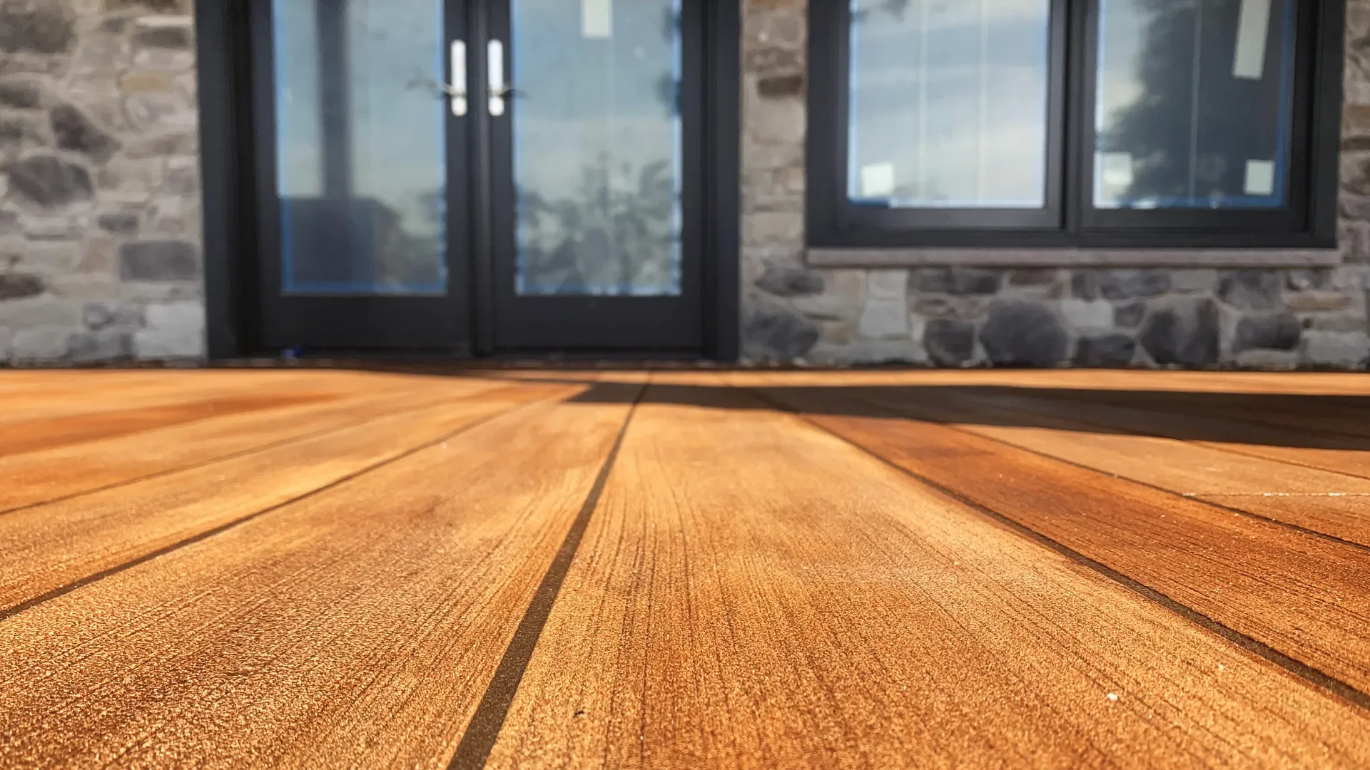 Rustic Concrete Wood patio epoxy flooring system resembling natural hardwood, installed by TVS Coatings in Idaho