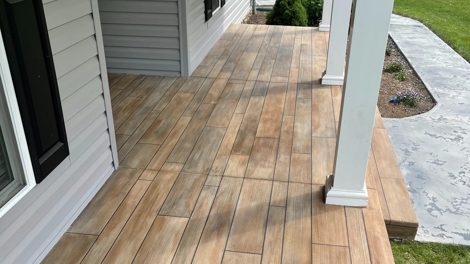 Rustic Concrete Wood epoxy flooring on front porch in Idaho installed by TVS Coatings, featuring a realistic wood plank design