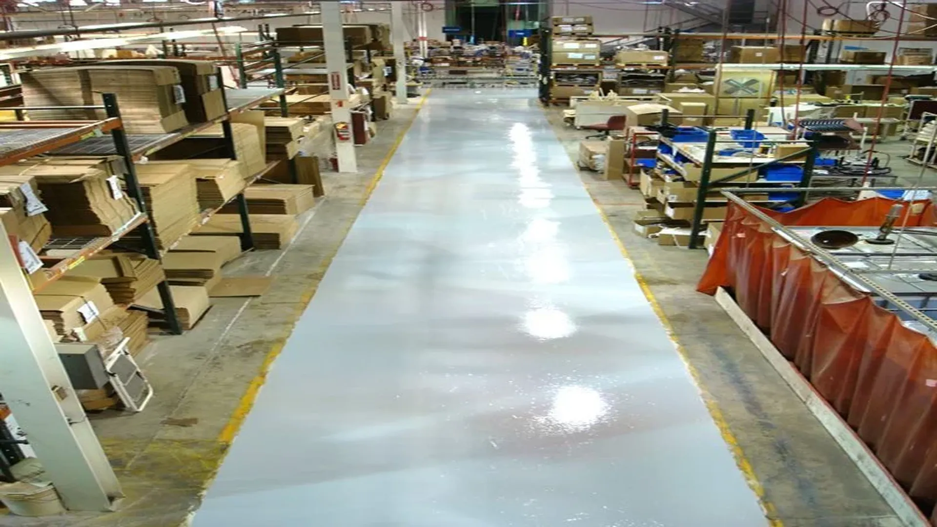 Epoxy flooring in warehouse aisle with high-performance resinous coating.