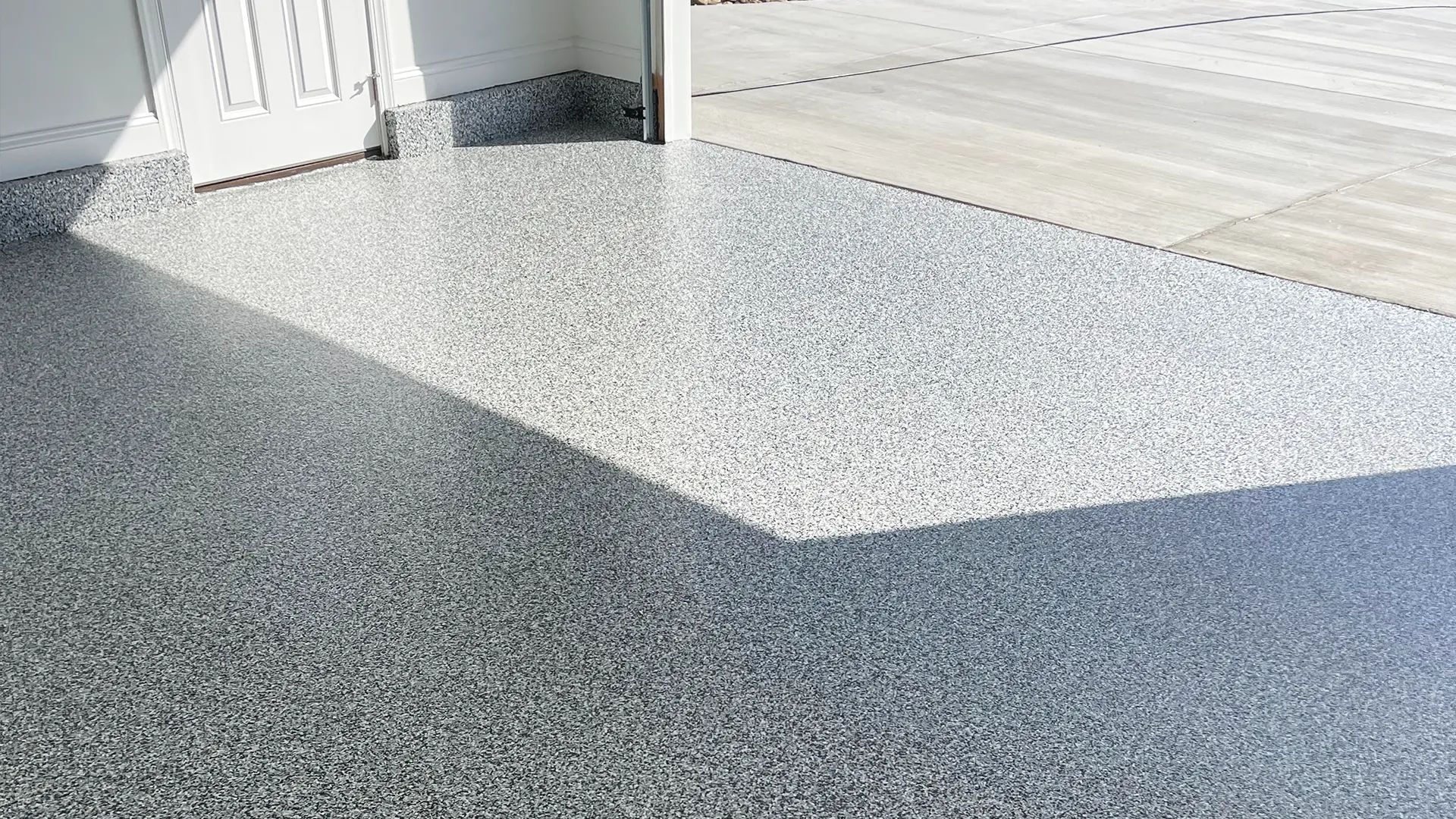 Graniflex-coated garage floor with a durable, slip-resistant, and showroom-quality finish that protects and enhances the space.