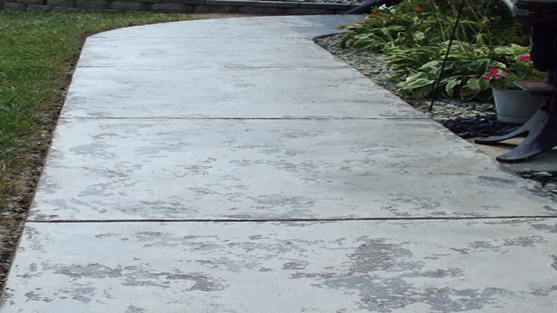 Tuscan slate sidewalk with decorative concrete texture coated by TVS Coatings in Idaho.